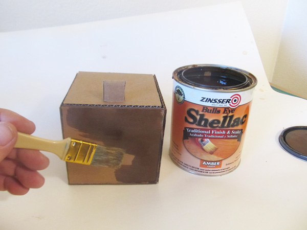 Applying shellac to cardboard