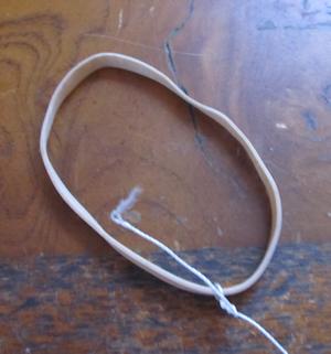 Tie a string to a rubber band
