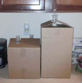 Cardboard boxes being used as covers for carboys