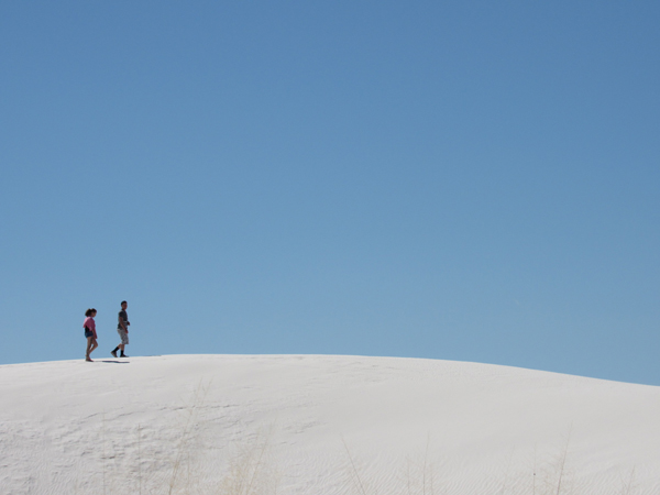 A couple walking on the white sands
