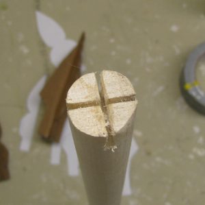 Cut notches in the dowel or broomstick