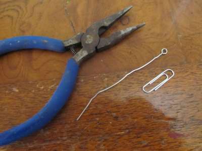 Bend the paper clip with pliers