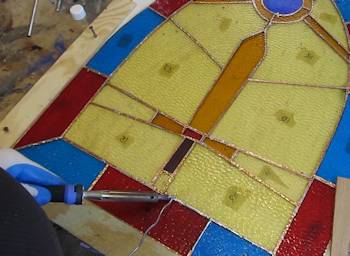Soldering the back side of the stained glass window